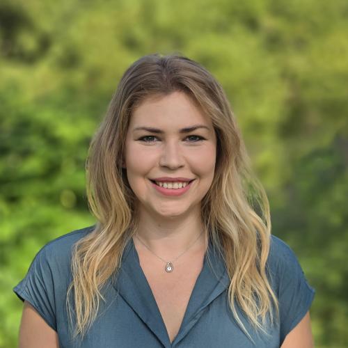 A photo of Mary Oropeza with greenery on the background